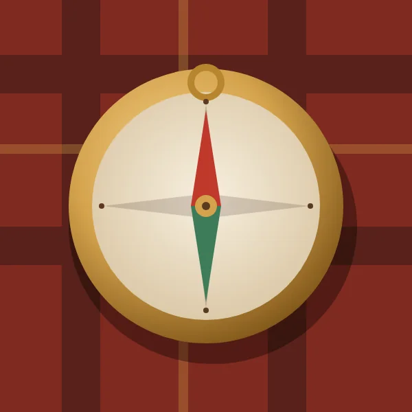 Brass compass resting on a plaid blanket